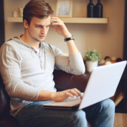 Student sitting and working on laptop