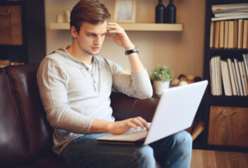 Student sitting and working on laptop